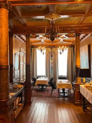 a dining room with two tables and a chandelier at Huis Dujardin Bed&Breakfast in Antwerp