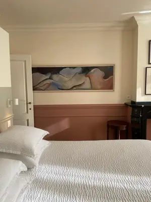 a bedroom with a painting on the wall at Huis Dujardin Bed&Breakfast in Antwerp