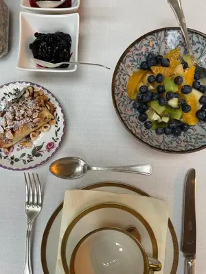 a table topped with plates of food and bowls of fruit at Huis Dujardin Bed&Breakfast in Antwerp