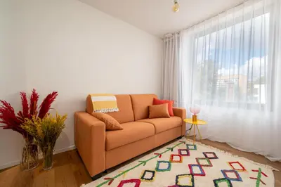 a living room with a couch and a window at Georges & Madeleine Apartments in Aalst