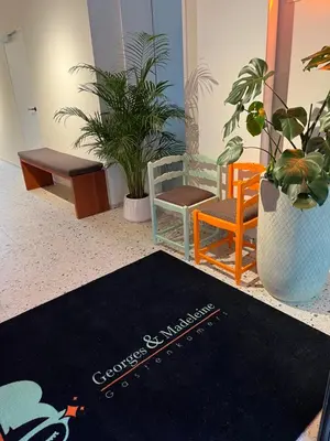a lobby with chairs and a rug on the floor at Georges & Madeleine Apartments in Aalst