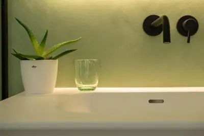 a plant in a glass sitting on top of a table at Georges & Madeleine Apartments in Aalst