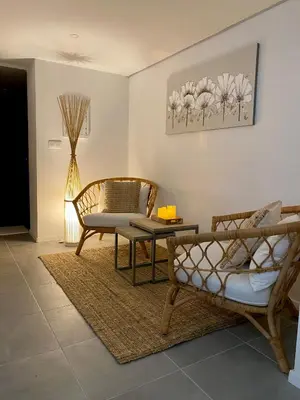 a living room with a couch and a table and chairs at Superbe logement près de Bruxelles avec spa privé in Brussels