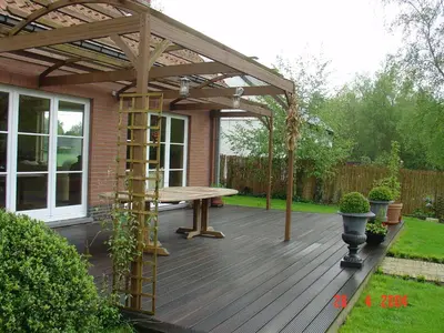 a wooden deck with a wooden pergola at B2B-flats in Ternat