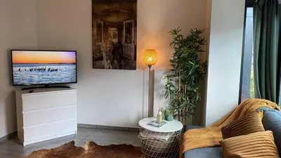 a living room with a tv and a couch at Oneluxstay Antwerp City Centre in Antwerp