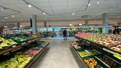 a grocery store aisle with fruits and vegetables on display at Oneluxstay Antwerp City Centre in Antwerp