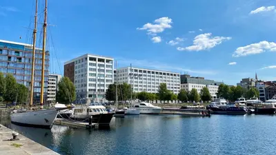 a group of boats docked in a harbor with buildings at Oneluxstay Antwerp City Centre in Antwerp