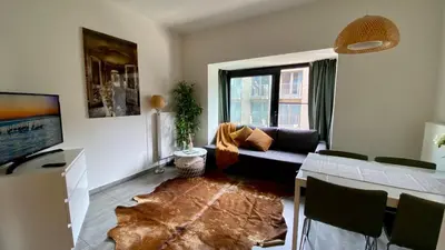 a living room with a couch and a tv at Oneluxstay Antwerp City Centre in Antwerp