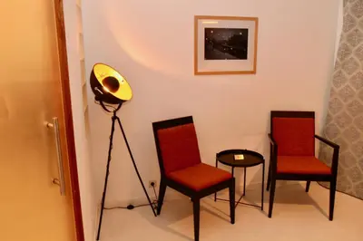 a room with two chairs and a lamp and a table at B&B Allegra Nova in Ghent