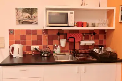 a kitchen with a sink and a microwave at B&B Allegra Nova in Ghent