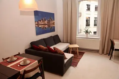 a living room with a couch and a table at B&B Allegra Nova in Ghent