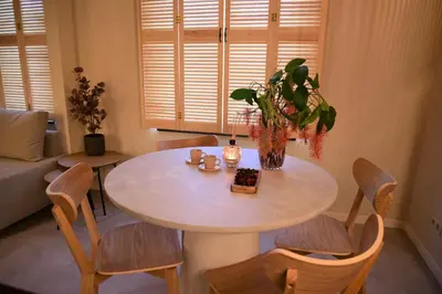 a table and chairs in a living room at Sabi Stay Antwerp in Antwerp