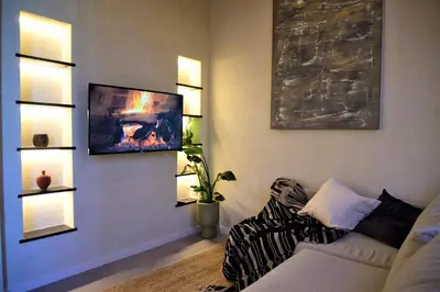 a living room with a couch and a painting on the wall at Sabi Stay Antwerp in Antwerp