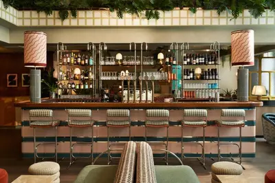 a bar with chairs and a counter in a restaurant at The Hoxton, Brussels in Brussels