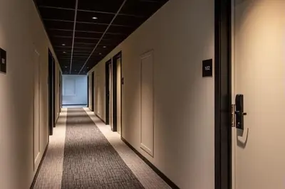 a hallway with a row of doors in a building at ibis Brussels Groot Bijgaarden in Groot-Bijgaarden