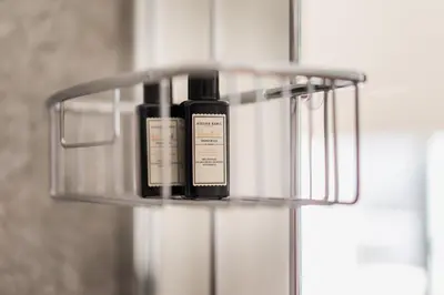 a bottle of perfume sitting on a shelf in a bathroom at Quartier Le Sud in Antwerp