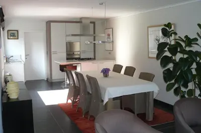 a kitchen and dining room with a table and chairs at Holiday Home and Office Domisi'l in Wachtebeke