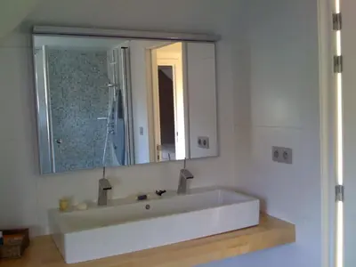 a bathroom with a large white tub with a mirror at Holiday Home and Office Domisi'l in Wachtebeke