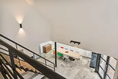 a dining room with a table in a house at Schitterende loft met jacuzzi en sauna in Mechelen in Mechelen