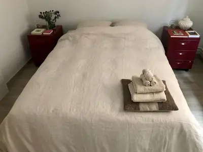 a bed with towels and a teddy bear on it at Giorgio in Antwerp