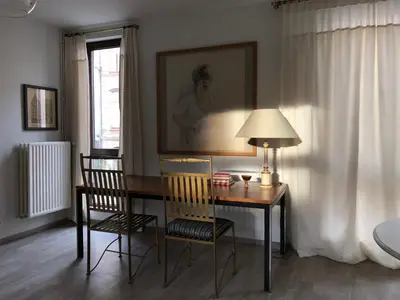 a dining room table with two chairs and a lamp at Giorgio in Antwerp