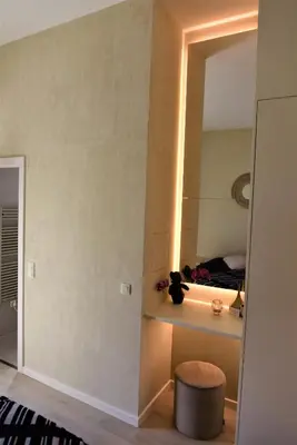 a room with a mirror and a stool and a bed at Japandi Apartment, Cityview Elevator in Antwerp