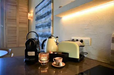 a kitchen counter with a coffee maker and affeepot at Japandi Apartment, Cityview Elevator in Antwerp