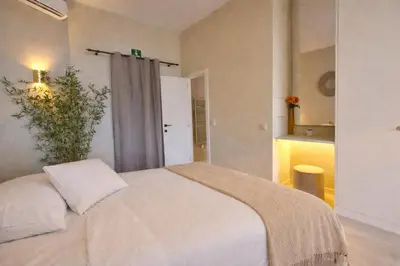 a bedroom with a white bed in a room at Japandi Apartment, Cityview Elevator in Antwerp