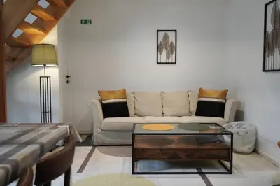 a living room with a couch and a coffee table at The Suite Escape Apartment Sand in Sint-Lievens-Houtem