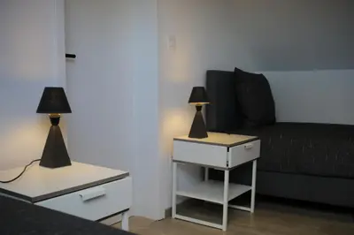 two lamps on tables in a living room with a couch at The Suite Escape Apartment Sand in Sint-Lievens-Houtem