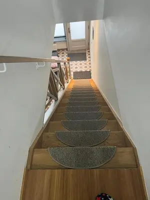 a staircase with wooden floors and a stair case at Au Marolles chambre Atomium in Brussels