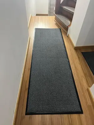 a black rug on the floor in a room at Au Marolles chambre Atomium in Brussels
