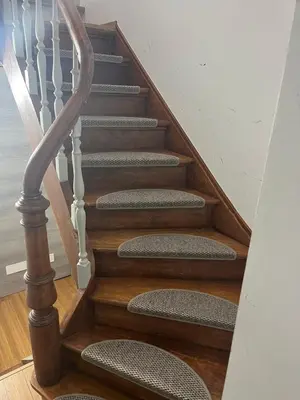 a stairway with a wooden rail and wooden stairs at Au Marolles chambre Atomium in Brussels