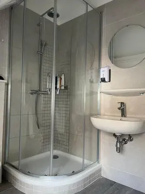 a bathroom with a shower and a sink at Au Marolles chambre Atomium in Brussels
