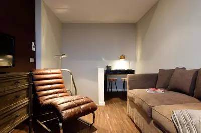 a living room with a couch and a chair at Apartment Nyhuset in Brussels