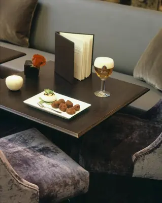 a table with a plate of food and a glass of wine at Apartment Nyhuset in Brussels