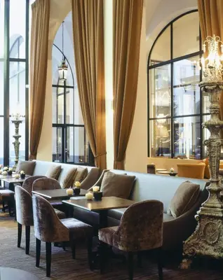 a waiting room with couches and tables and windows at Apartment Nyhuset in Brussels