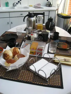 a kitchen counter with a table with a tray of food at B&B Middelheim in Antwerp
