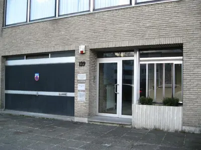 two garage doors on a brick building at B&B Middelheim in Antwerp