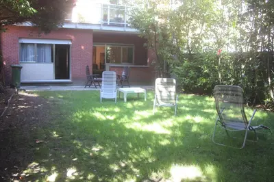 a group of chairs sitting in a yard at B&B Middelheim in Antwerp