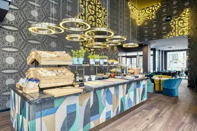 a restaurant with a counter with a counter sidx sidx sidx at Motel One Brussels in Brussels