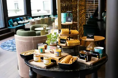 a table with food on it in a restaurant at Motel One Brussels in Brussels