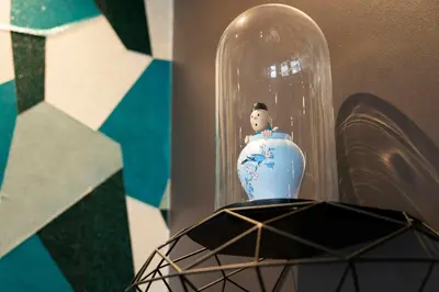 a vase in a glass dome sitting on a table at Motel One Brussels in Brussels