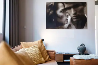 a living room with a couch and a painting on the wall at Hotel Elisabeth in Mechelen