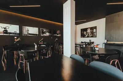 a restaurant with tables and chairs and pictures on the walls at Hotel Elisabeth in Mechelen