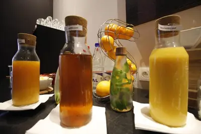 three bottles of orange juice sitting on a counter at Hotel Elisabeth in Mechelen