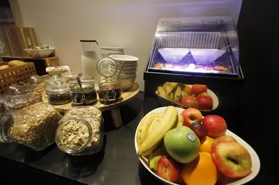 a buffet of food with fruits and vegetables on a counter at Hotel Elisabeth in Mechelen