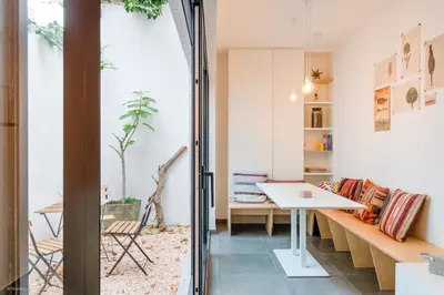 a room with a table and a bench and a table at Stylishly furnished private home in a vibrant area in Antwerp