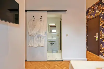 a bathroom with a shower and a sink at Hotel Les Ecrins in Brussels