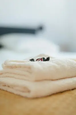 a stack of towels sitting on a table at Apartment The City in Ghent